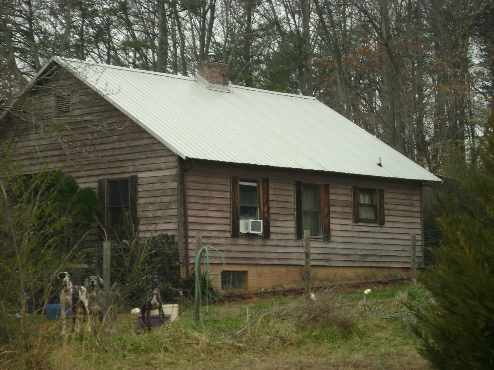 White metal roof on an old wood sided farmhouse, from a Metal Roof Installation job in Beaver Dams